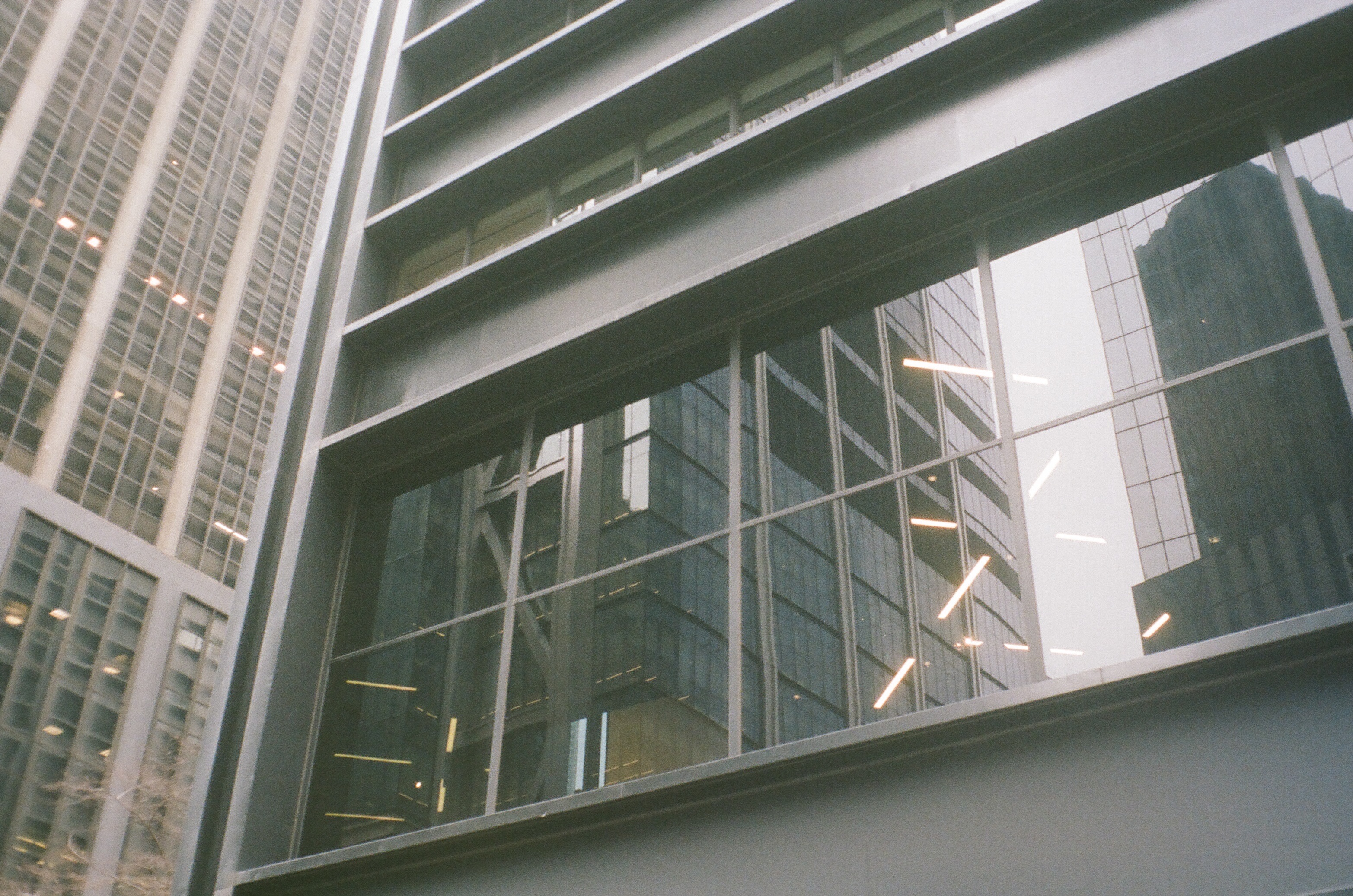 A close shot of the US Steel Building in lower manhattan with lots of reflective inside and outside lights going on